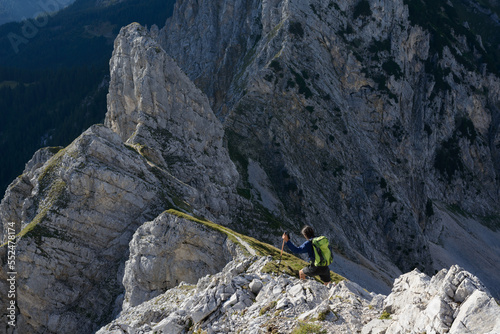 Mountaineer  on rocky ridge, evening light in wild terrain