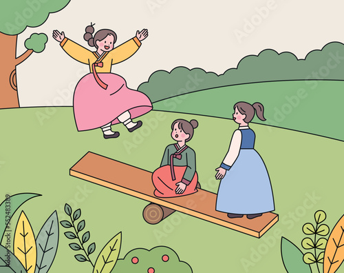 Three girls wearing hanbok are riding on a traditional Korean seesaw.