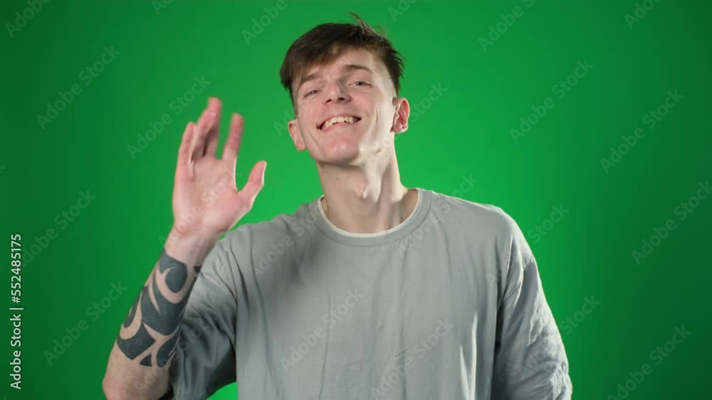 Smiling man wearing t-shirt greeting Smiling man wearing t-shirt greeting