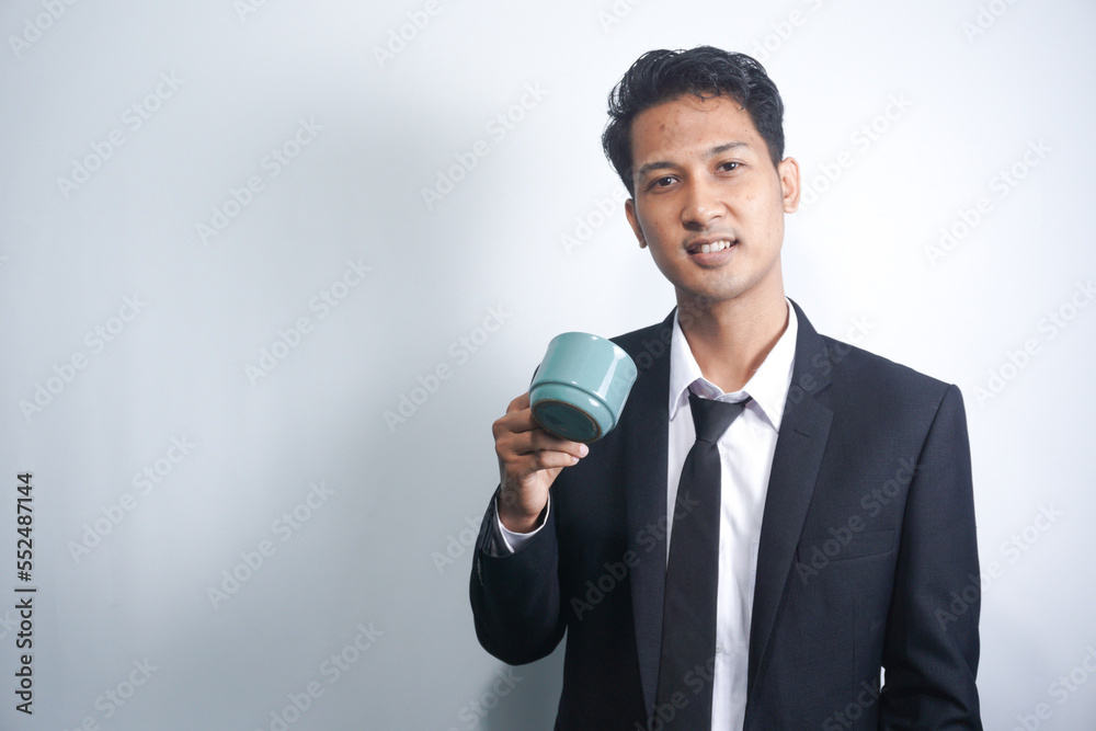Young Business Man Drinking a Cup of Coffee or Tea Young Business Man Drinking a Cup of Coffee or Tea
