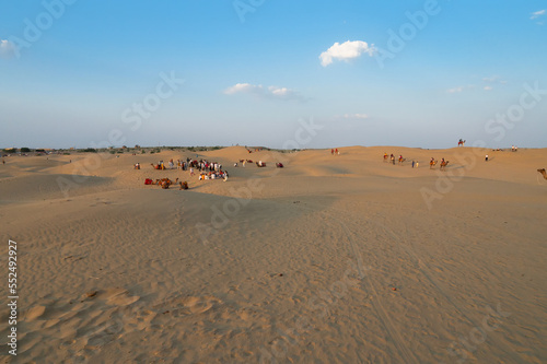 Tourists with camels  Camelus dromedarius  at sand dunes of Thar desert  Rajasthan  India. Camel riding is a favourite activity amongst all tourists visiting here.