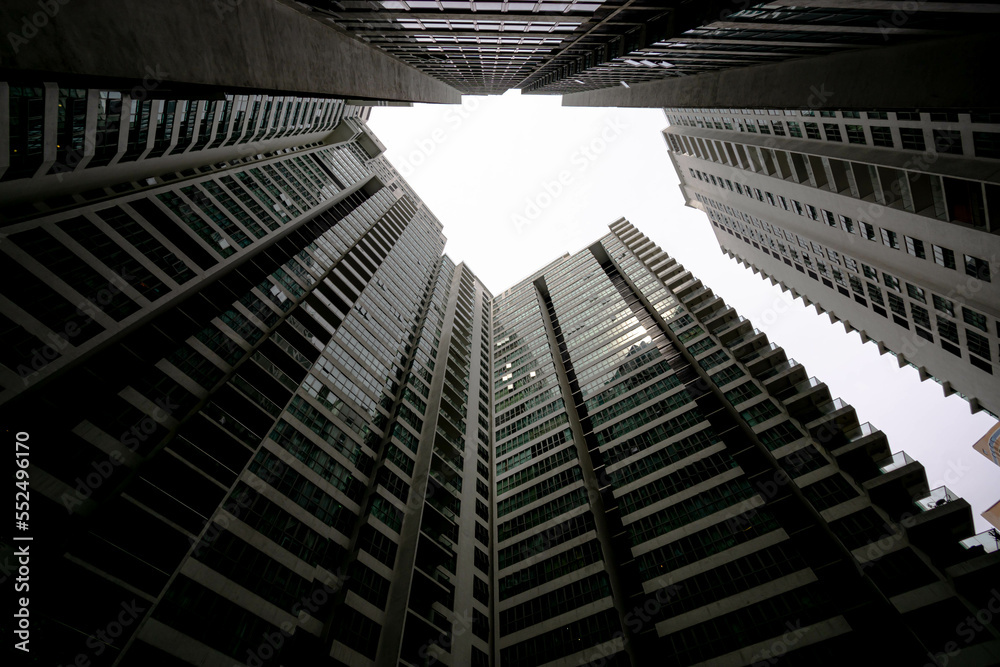 Low angle shot of modern glass city buildings with clear sky background.
Low angle shot of modern glass city buildings with clear sky background.