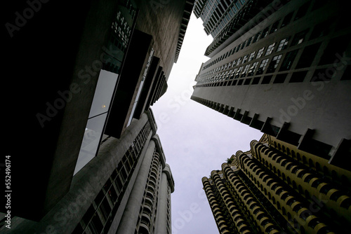 Low angle shot of modern glass city buildings with clear sky background. 