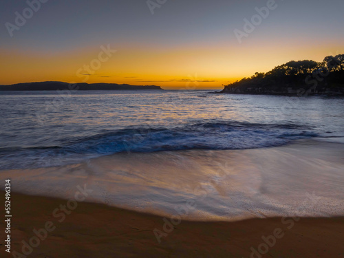 Aerial sunrise seascape with calm seas and a clear sky