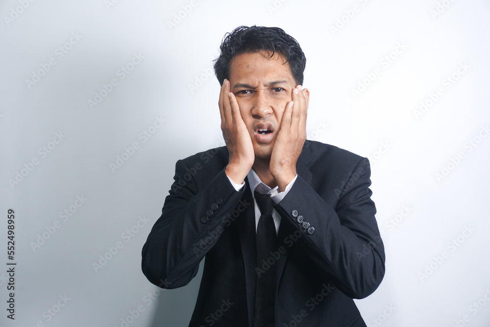 Tooth ache concept. Indoor shot of young male feeling pain, holding his cheek with hand, suffering from bad toothache, looking at camera with painful expression Tooth ache concept. Indoor shot of young male feeling pain, holding his cheek with hand, suffering from bad toothache, looking at camera with painful expression