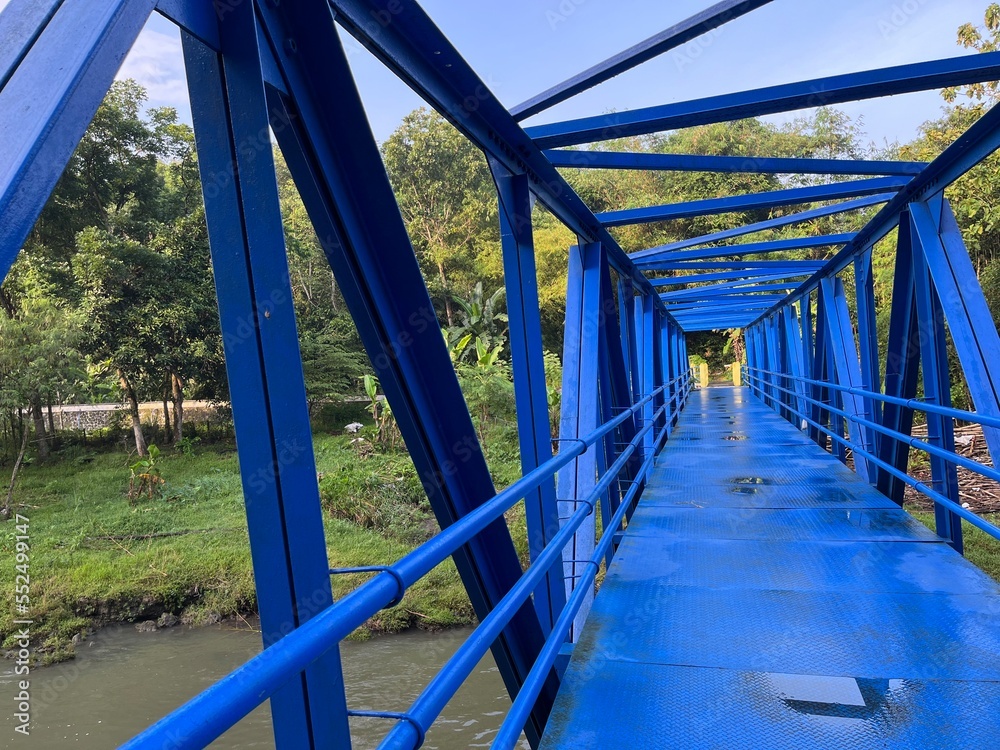 View at Lava Bantal located in Yogyakarta, Indonesia. There is bridge in blue color for crossing the river. View at Lava Bantal located in Yogyakarta, Indonesia. There is bridge in blue color for crossing the river.