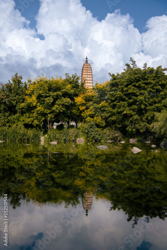Dali's three ancient pagodas reflecting on a lake in a cloudy day, Dali, Yunnan, China