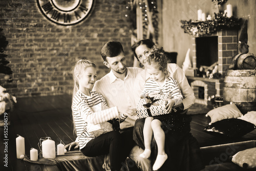 happy family with Christmas gifts sitting in a cozy living room. black and white photo