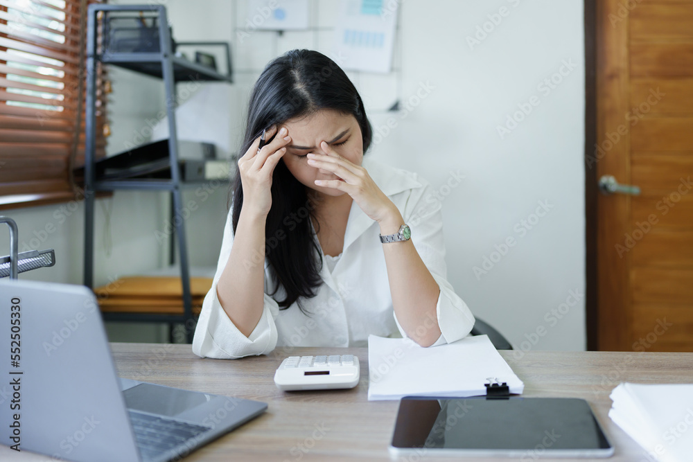 Portrait of sme business owner, woman using computer and financial statements Anxious expression on expanding the market to increase the ability to invest in business Portrait of sme business owner, woman using computer and financial statements Anxious expression on expanding the market to increase the ability to invest in business