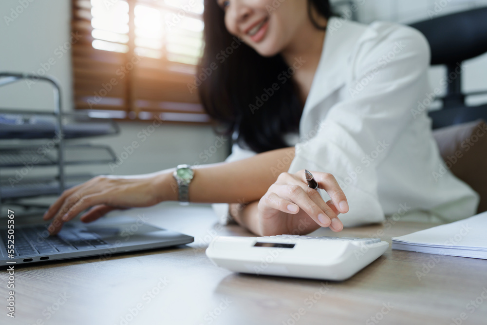 Accountants, Asian auditors are using calculators and computers to review annual tax budgets to submit information to the IRS. Accountants, Asian auditors are using calculators and computers to review annual tax budgets to submit information to the IRS.