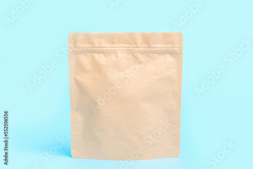 A brown kraft package close-up on blue background.