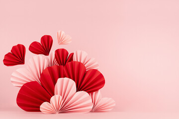 Sweet happiness Valentine day scene mockup - pink and red origami paper hearts on pink background with copy space. Romantic template for advertising, cosmetic product display and greeting card.