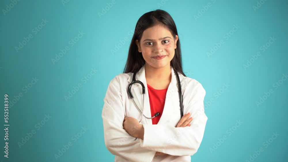 Portrait of a young female doctor wearing apron and stethoscope, Cheerful Asian Indian woman doctor isolated over blue studio background Portrait of a young female doctor wearing apron and stethoscope, Cheerful Asian Indian woman doctor isolated over blue studio background