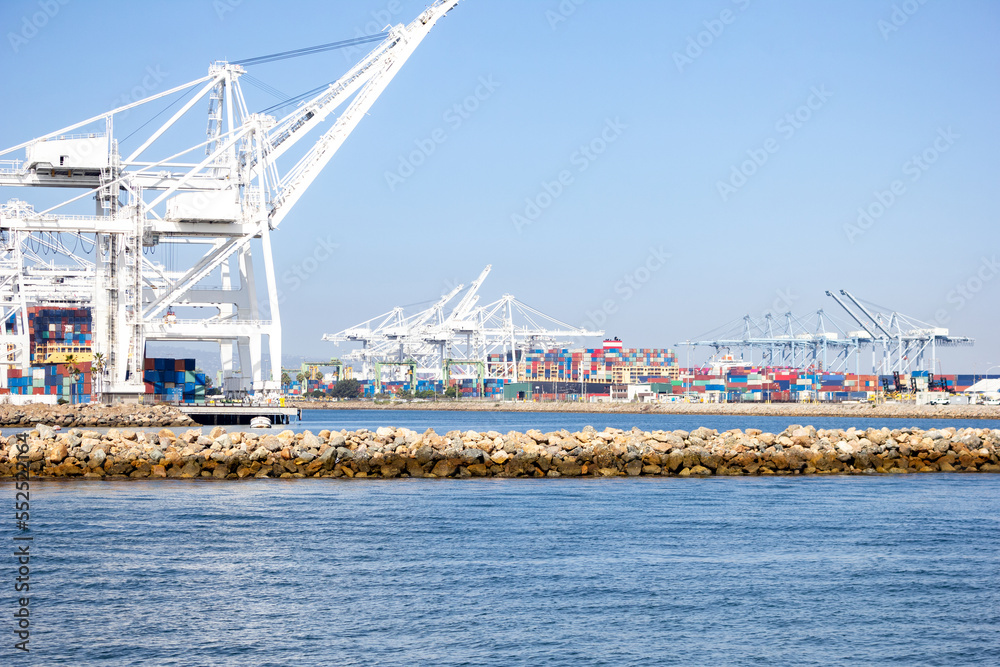 A view of several large loading cranes ready for unloading shipping containers off ships, in a local city port.