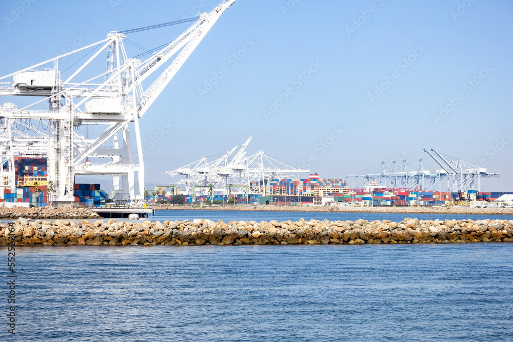 A view of several large loading cranes ready for unloading shipping containers off ships, in a local city port. A view of several large loading cranes ready for unloading shipping containers off ships, in a local city port.