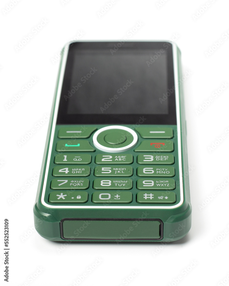 Green push-button mobile phone on a white background. Cell phone, focus on buttons. Green push-button mobile phone on a white background. Cell phone, focus on buttons.