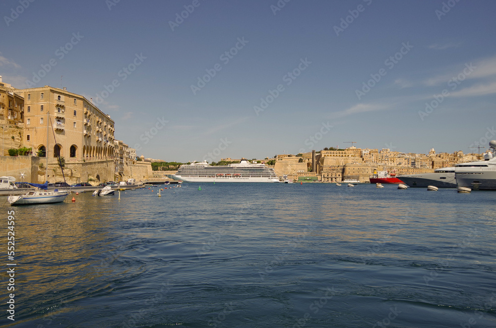 Viking luxury cruiseship or cruise ship liner Star in La Valletta, Malta port during Mediterranean cruise dream vacation on sunny day blue sky and historic old town skyline
