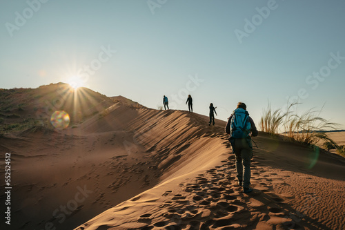 Foto im Gegenlicht - Touristen besteigen die Elim D  ne bei Sonnenuntergang  Sesriem  Namibia 