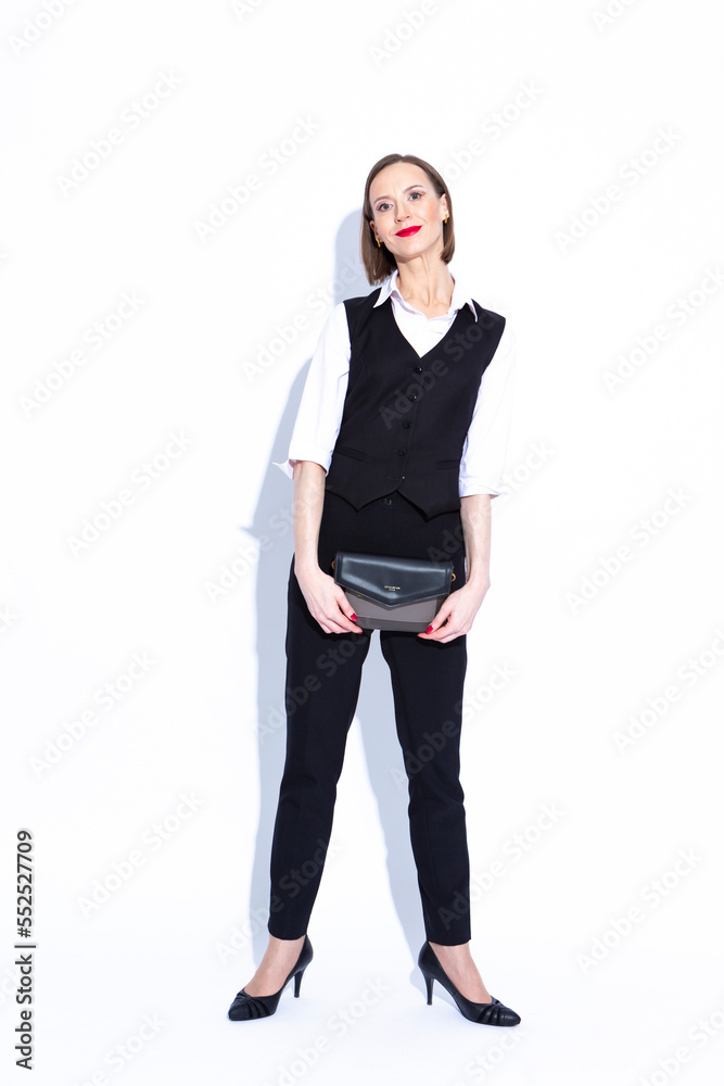 Women In Business. Full Length Portrait of Winsome Positive Confident Caucasian Business Woman in White Shirt Posing With Clutch Over White Background. Women In Business. Full Length Portrait of Winsome Positive Confident Caucasian Business Woman in White Shirt Posing With Clutch Over White Background.