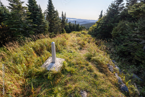 stone marker indicates international boundary between USA Canada photo