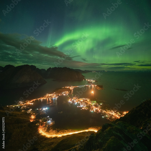 Northern lights over Reine from Reinebringen, Lofoten Islands, Norway photo