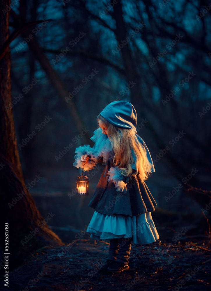 Girl with candle in the night forest