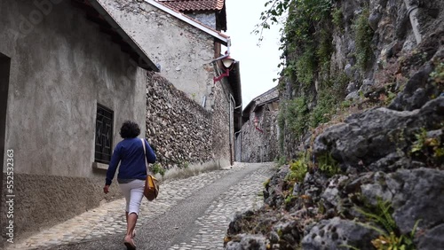 woman walk on the street of Tarascon sur Ariege, France photo