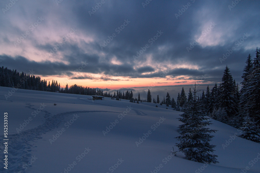 Sunset on mountain slopes landscape photo. Beautiful nature scenery photography with snowy wilderness on background. Idyllic scene. High quality picture for wallpaper, travel blog, magazine, article