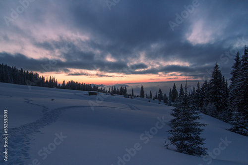 Sunset on mountain slopes landscape photo. Beautiful nature scenery photography with snowy wilderness on background. Idyllic scene. High quality picture for wallpaper  travel blog  magazine  article