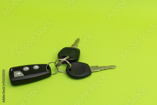 Car keys on green background