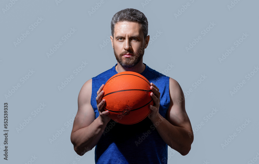 photo of sport man basketball player holding ball. sport man basketball player in sportswear