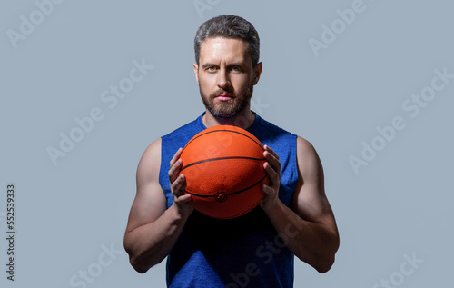 photo of sport man basketball player holding ball. sport man basketball player in sportswear