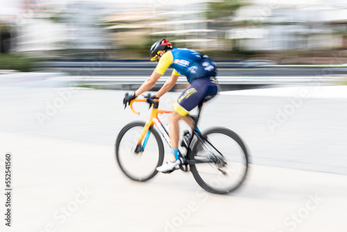 colourfully dressed cyclist passing by very fast © TropicalNinjaStudio