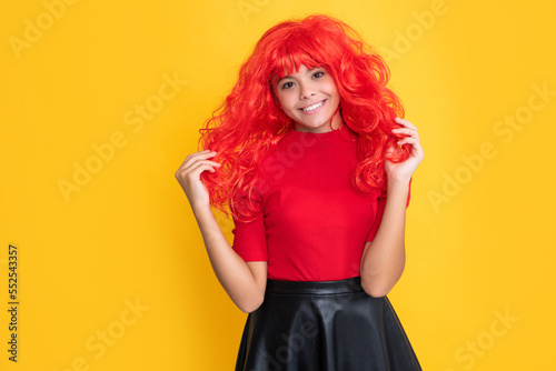 glad kid with red long hair on yellow background