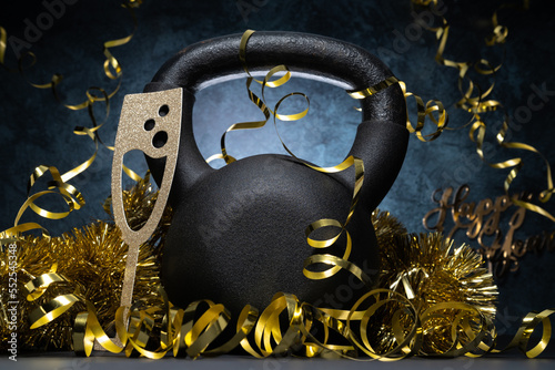 Canvas Print Heavy kettlebell and golden decorations, party streamers for New Year's Eve celebration, birthday or carnival