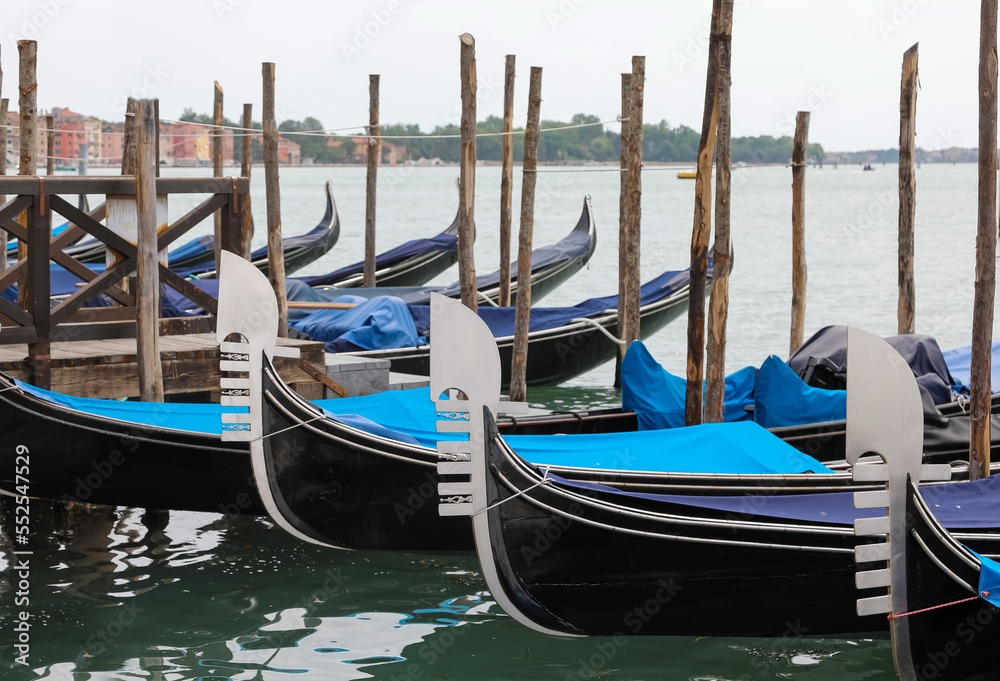 moored gondolas typical Venetian boats in the basin near Saint Mark Square in Venice in Italy WITHOUT PEOPLE