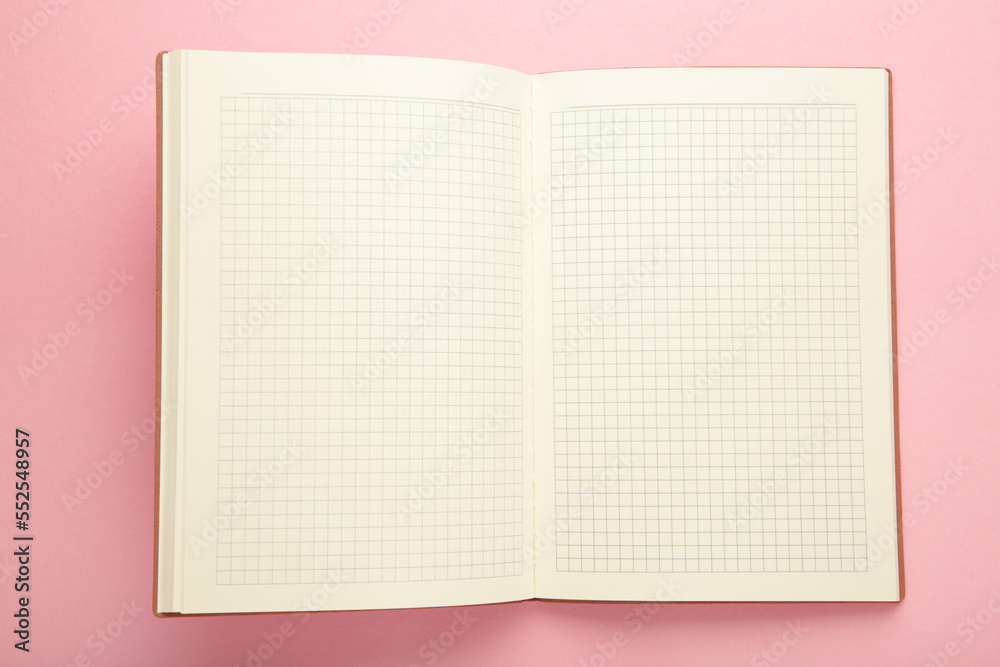 Open notebook on pink background. Business concept. Open notebook on pink background. Business concept.