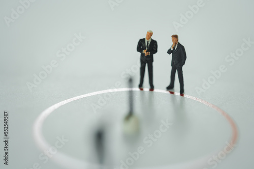 Miniature people: small figures businessmen stand on top of circle, performance as background strategy concept and Business concept with copy space.