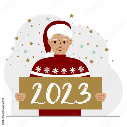 A man in a red sweater and with a cap holds a sign or poster with the numbers 2023. Postcard or greeting Merry Christmas and Happy New Year. © Sunny_baby