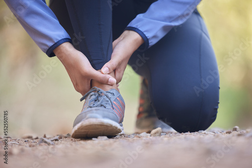 Running, ankle pain and injury with shoes of black woman on nature trail for training, jogging and endurance. Sprain, accident and broken with girl runner on path for workout, exercise and sports