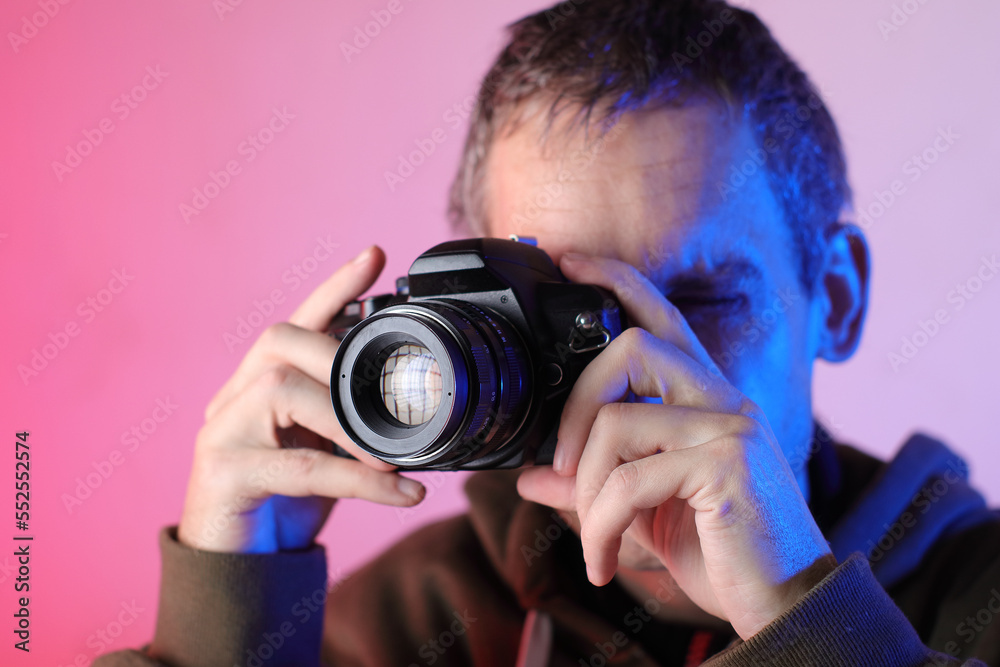 digital slr camera with an old lens in the hands of a person