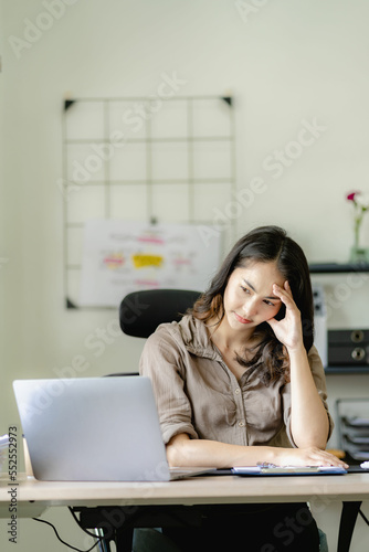 Asian businesswoman handling accounting tasks Accounting group meeting online and using laptop computer Professional confident employees in the office