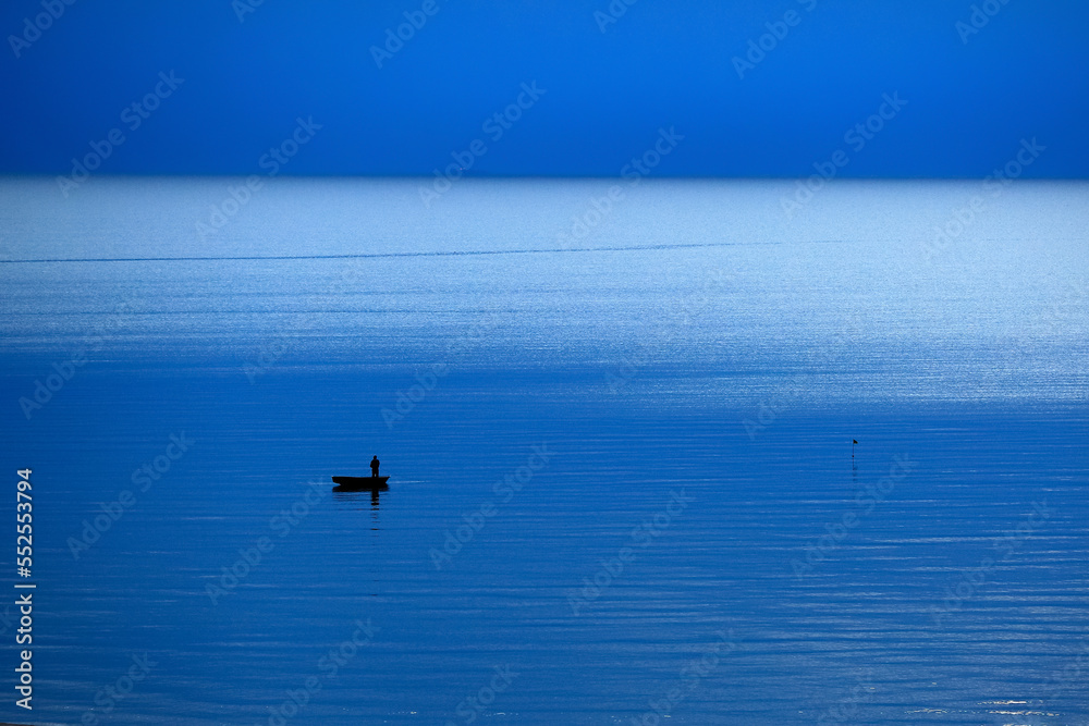 Fototapeta premium The fishman in the Rigas bay , Saulkrasti beach in Latvia