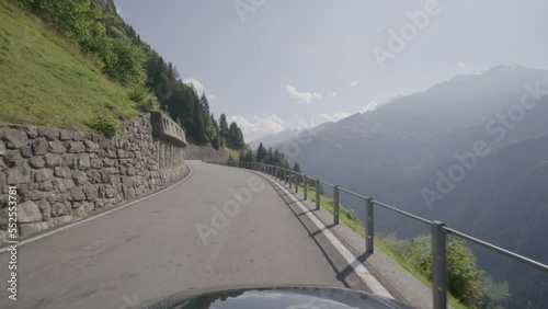 Driving video of the Sustenpass in Switzerland. The Susten pass is a famous alp road and has a scenic mountain panorama. View from the car. Experience calming nature and exciting pass roads. photo
