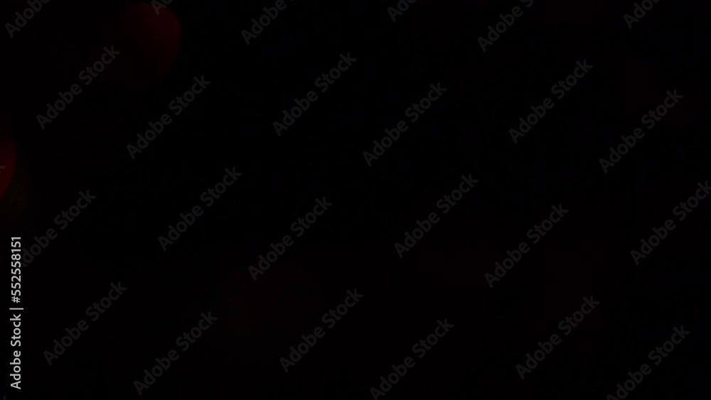 Iridescent Christmas bokeh motion background. Christmas bokeh transition for footages. Glittering green and red defocused bokeh circles move beautifully from corner to corner.