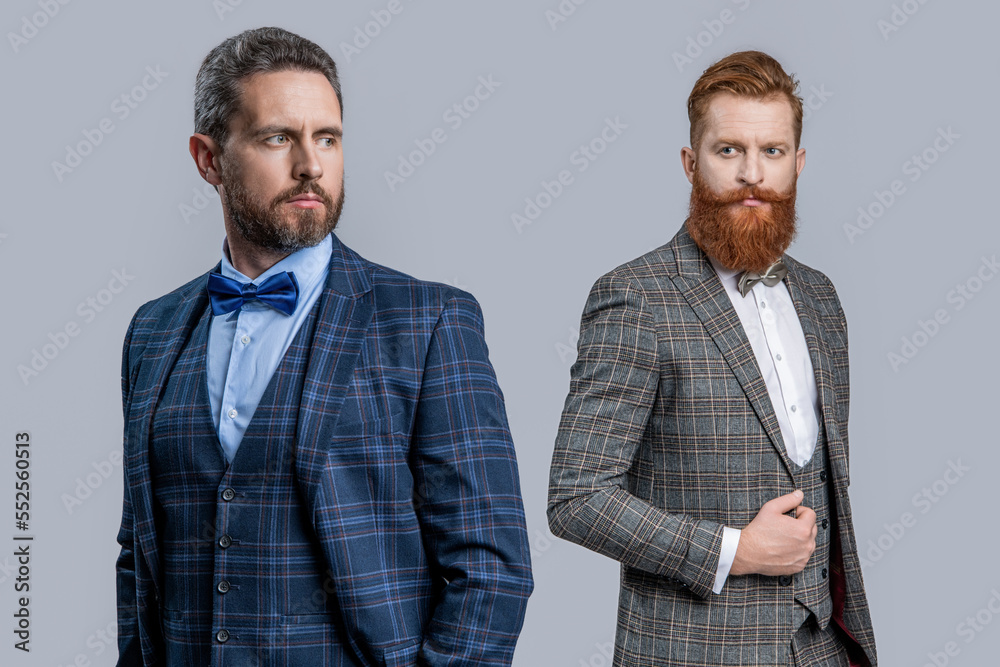 two men in tuxedo bowtie. studio shot of men wearing bowtie and tuxedo. elegant men two men in tuxedo bowtie. studio shot of men wearing bowtie and tuxedo. elegant men