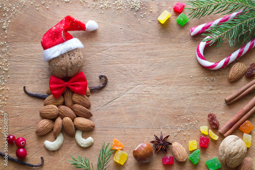 Santa Claus made of almonds with dried fruit and nuts on wooden background, christmas food concept