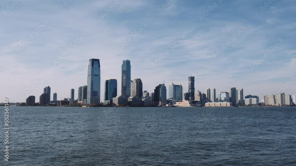 Skyline of New Jersey with wispy clouds across Hudson River from Manhattan, Wide Skyline of New Jersey with wispy clouds across Hudson River from Manhattan, Wide