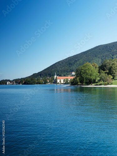 Tegernsee in Bavarian Alps. Promenade on the Shoreline of Rottach-Egern with view to the Benedictine monastery or Tergernsee Abbey tody a Schloss in Tegernsee