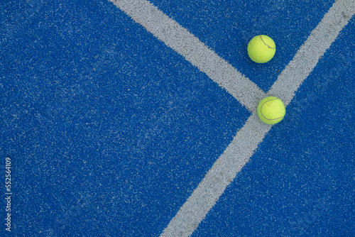 selective focus, two balls on a blue paddle tennis court where the lines meet. Racket sports © Vic